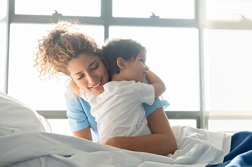 nurse hugging pediatric patient - kidney transplant program